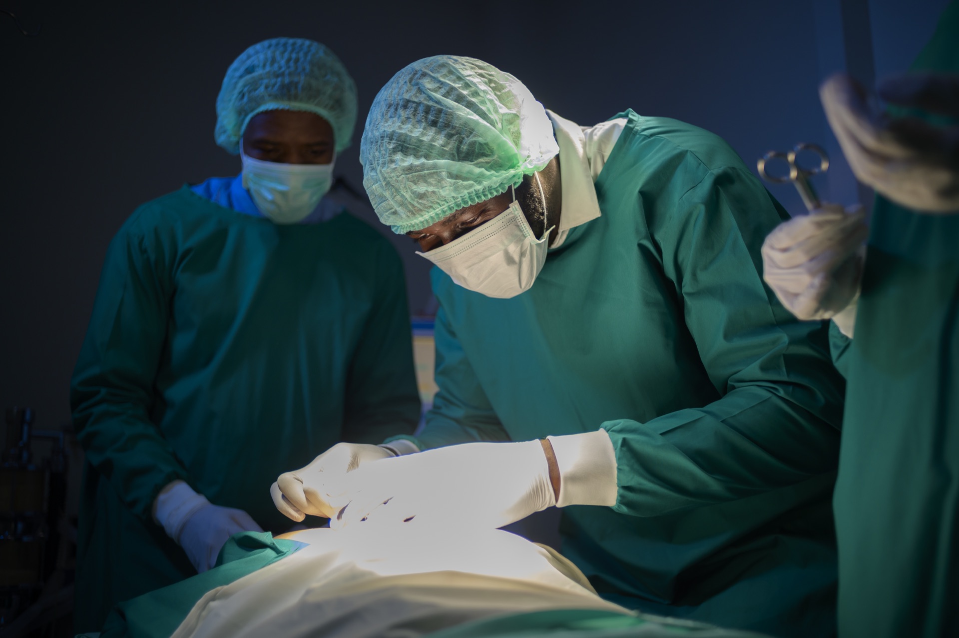 A team of surgeons operating in a mission hospital surgical theater.